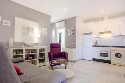 a living room with a couch and a table at Pinar 12 in Chiclana de la Frontera