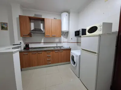 a kitchen with a refrigerator and a washing machine at Apartamento Feduchy in Cádiz