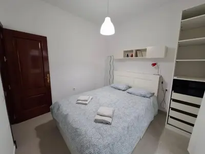 a bedroom with a bed with two towels on it at Apartamento Feduchy in Cádiz