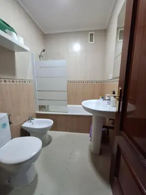 a bathroom with a toilet and a sink and a tub at Apartamento Feduchy in Cádiz