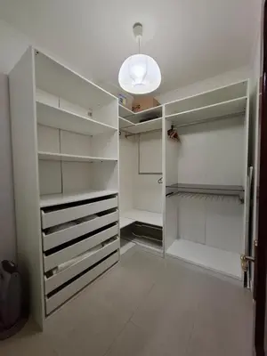 a walk in closet with white cabinets and a light at Apartamento Feduchy in Cádiz