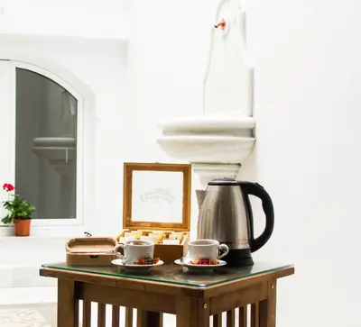 a table with a coffee pot and cups on it at 7Escalones in Rota