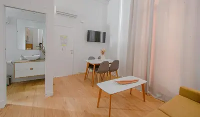 a living room with a table and a bathroom at 7Escalones in Rota