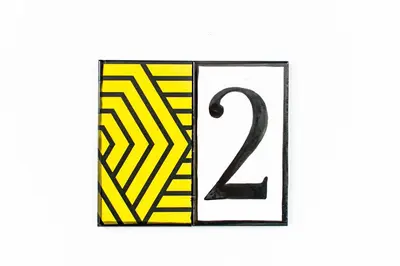 a yellow and black rectangle with a number on it at 7Escalones in Rota