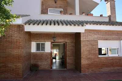 a red brick house with a door entrance at Casa/Chalet Doñana in Sanlúcar de Barrameda