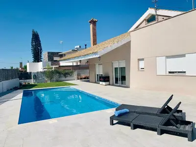a swimming pool in the backyard of a house at Casa/Chalet Doñana in Sanlúcar de Barrameda