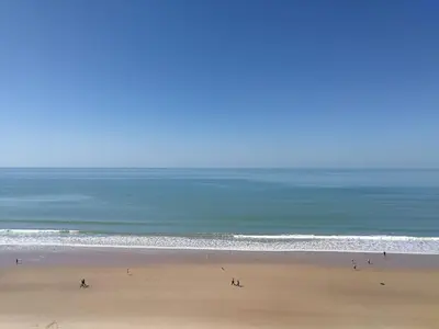 a group of people on a beach near the ocean at Vivienda Vistahermosa Playa in El Puerto de Santa María