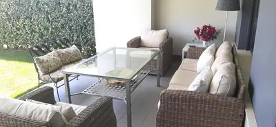 a living room with chairs and a glass table at Vivienda Vistahermosa Playa in El Puerto de Santa María