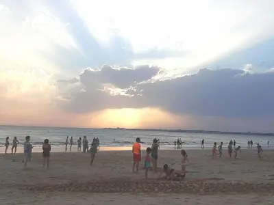 a group of people on the beach at sunset at Vivienda Vistahermosa Playa in El Puerto de Santa María
