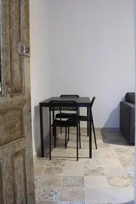 a black table and chair in a room at Campo del Sur - Catedral in Cádiz