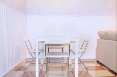 a dining room table and chairs in a room at Campo del Sur - Catedral in Cádiz
