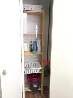 an open door of a kitchen pantry with a shelf at Apartamento !!VIVE JEREZ!! in Jerez de la Frontera