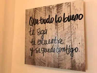 a sign hanging on a wall with writing on it at Apartamento !!VIVE JEREZ!! in Jerez de la Frontera