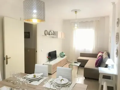 a living room with a couch and a table at Apartamento !!VIVE JEREZ!! in Jerez de la Frontera