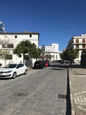 a white car parked on the side of a street at Apartamento !!VIVE JEREZ!! in Jerez de la Frontera