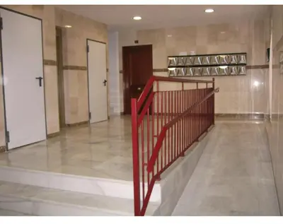 a hallway with a red staircase in a building at Playa caleta 7 min, wifi, catedral, centro in Cádiz