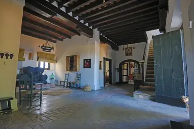 a large living room with a staircase in a house at LA BENDITA LOCURA in El Puerto de Santa María