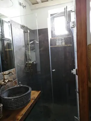 a bathroom with a sink and a glass shower at LA BENDITA LOCURA in El Puerto de Santa María