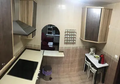 a small kitchen with a sink and a counter at Apartamento Entre el Falla y la Caleta in Cádiz