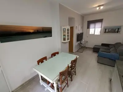 a living room with a table and a couch at Apartamento La Domus in Cádiz