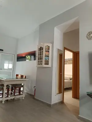 a room with a table and a room with a bedroom at Apartamento La Domus in Cádiz