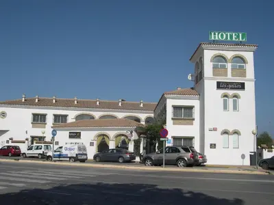 a hotel with cars parked in front of it at Hotel Cortijo Los Gallos in Chiclana de la Frontera