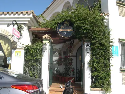 a building with a sign on the front of it at Hotel Cortijo Los Gallos in Chiclana de la Frontera