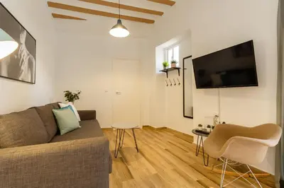 a living room with a couch and a flat screen tv at Balcones de CANDELARIA by Cadiz4Rentals in Cádiz