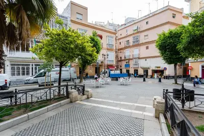 a city street with tables and chairs and buildings at Balcones de CANDELARIA by Cadiz4Rentals in Cádiz