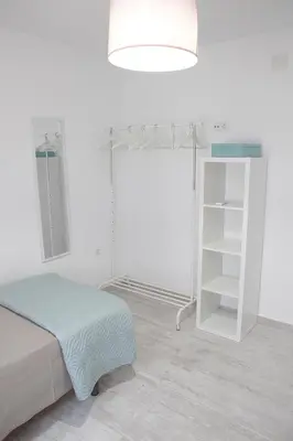 a white room with a bed and a white shelf at SHERRY HOME in Jerez de la Frontera