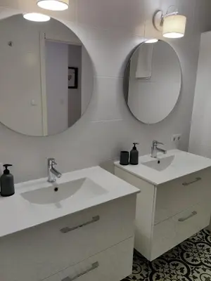 a bathroom with two sinks and a mirror at SHERRY HOME in Jerez de la Frontera