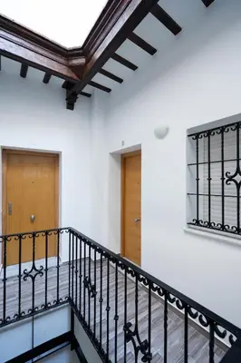 a staircase in a building with a ceiling at Encantador loft Teatro Falla in Cádiz