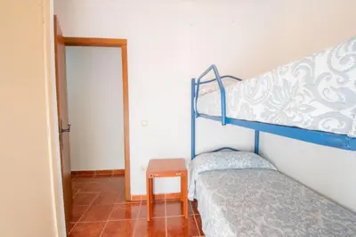 a bedroom with a bunk bed and a table at Casa Rural Napoleón in Medina Sidonia