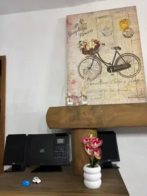 a table with a picture of a bike on a wall at Casa Rural Napoleón in Medina Sidonia