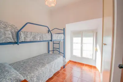 a bedroom with two bunk beds and a window at Casa Rural Napoleón in Medina Sidonia
