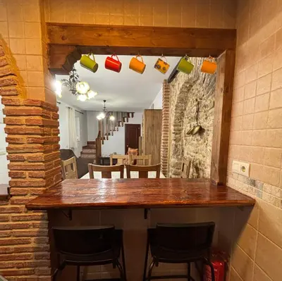 a bar in a room with chairs and a table at Casa Rural Napoleón in Medina Sidonia