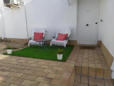 two chairs and a table on a patio at Ático en el centro con terraza in Cádiz