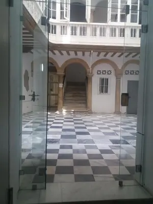 an empty room with a checkered floor in a building at Ático en el centro con terraza in Cádiz