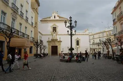 a group of people walking around a courtyard in a building at Ático en el centro con terraza in Cádiz