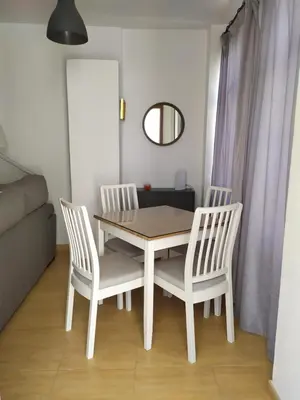 a dining room table and two chairs and a mirror at Ático en el centro con terraza in Cádiz