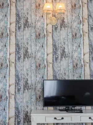 a television on a table in front of a wooden wall at Atico del ROMANTICO Gaditano by Cadiz4Rentals in Cádiz