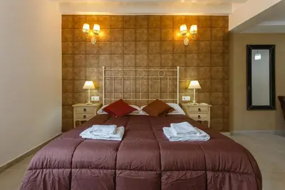 a bedroom with a large bed with towels on it at Atico del ROMANTICO Gaditano by Cadiz4Rentals in Cádiz