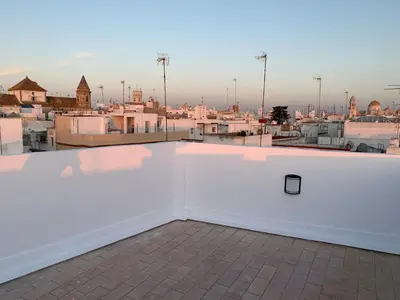 a white roof with a view of a city at Atico Terraza Cadiz Centro Ascensor Playa de la Caleta in Cádiz