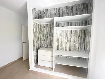 a closet with white shelves in a room at Chalet en Conil, descansa y disfruta BBQ AIRE PISCINA PARKING in Conil de la Frontera