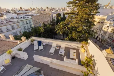 an overhead view of a rooftop patio with tables and chairs at Candelaria10 in Cádiz