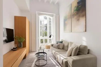 a living room with a couch and a tv at Candelaria10 in Cádiz
