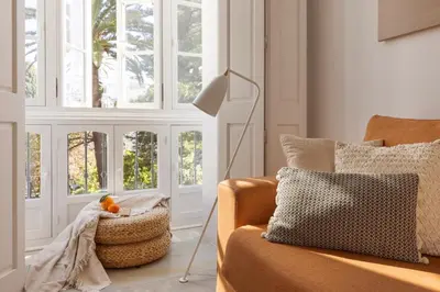 a living room with a couch and windows at Candelaria10 in Cádiz