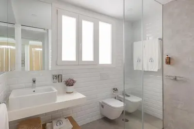 a white bathroom with a sink and a toilet at Candelaria10 in Cádiz