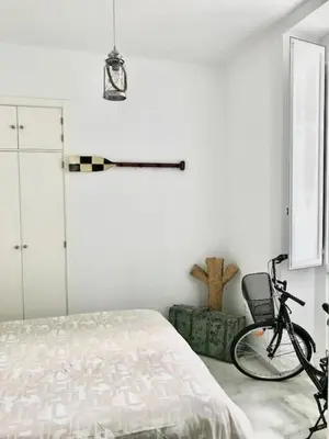 a bedroom with a bed and a bicycle on the floor at El Rinconcito - apartamento palacete rehabilitado in El Puerto de Santa María
