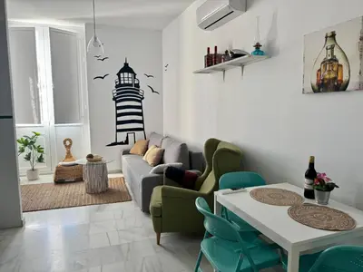 a living room with a couch and a table at El Rinconcito - apartamento palacete rehabilitado in El Puerto de Santa María